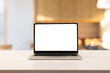 © chinnarach - close up on laptop with white blank isolated screen display on table over the luxury private of CEO or manager office room for add content and design about creative or business task concept