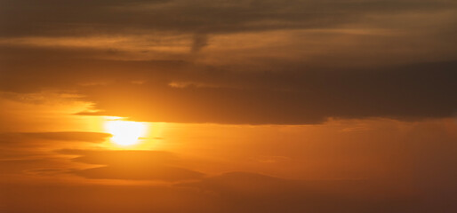 Wall Mural - beautiful bright evening sunset sky with dark clouds. sunset sky background.