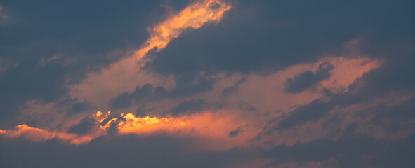 Wall Mural - beautiful bright evening sunset sky with dark clouds. sunset sky background.