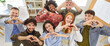 © Studio Romantic - Team of happy smiling young diverse casual people business company coworkers together in office workplace looking up at camera, making hand hearts, showing love to customers. Banner, high angle, above