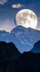 Wall Mural - vertical 9:16 Timelapse, a glowing full moon rises slowly over a rugged mountain ridge, casting soft silver light across the peaks. The night sky is dotted with stars, creating a serene cinematic view
