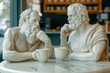© Magryt - Two white marble statues of Greek philosophers sitting at a caf? table, engaging in deep conversation over coffee. Philosophy, dialogue, intellect, and timeless discussion in a modern context.