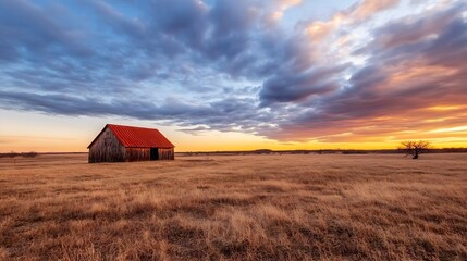 Poster - Rustic wooden barn with a red roof surrounded by golden fields under a colorful sky : Generative AI