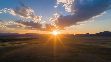 Aufkleber - Stunning Sunset Over Vast Prairie Landscape with Mountains in the Background : Generative AI