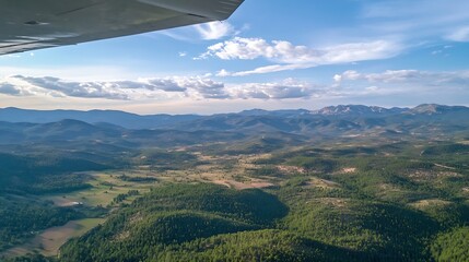 Poster - Aerial view of majestic mountain landscape with lush green forests and open fields under a bright blue sky : Generative AI