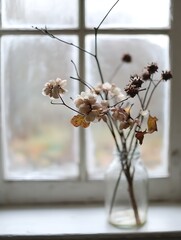 Poster - Delicate dried flowers and twigs in a glass jar set against a rainy window for a charming rustic aesthetic : Generative AI