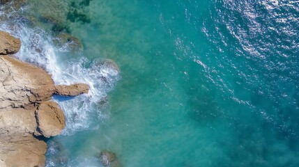 Aufkleber - Aerial view of crystal clear turquoise sea water gently lapping against rocky coastline : Generative AI