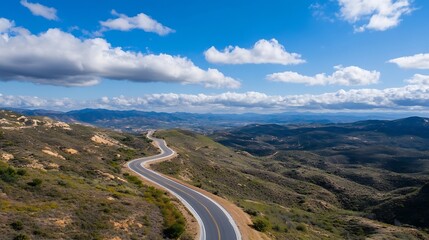 Poster - A winding road through green hills under a bright blue sky with fluffy clouds and stunning landscape views : Generative AI