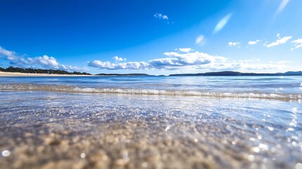Aufkleber - Clear Blue Waters Lapping Gently on a Sandy Beach Under a Bright Blue Sky with Fluffy Clouds : Generative AI