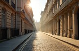 Historic London street scene bathed in morning sunlight. Cobbled road, lined with classical buildings creates peaceful urban landscape. Travel photo of old architecture. Golden hour light shines on
