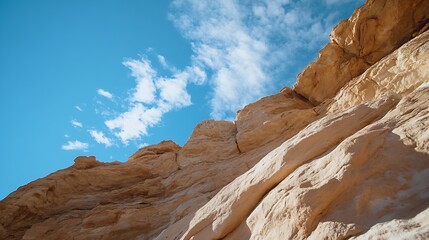 Aufkleber - Dramatic view of rocky cliffs against a bright blue sky with clouds : Generative AI