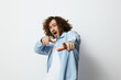 © SHOTPRIME STUDIO - Young man with curly hair dressed in a light blue shirt, expressing joy and enthusiasm against a simple white background Modern and vibrant style, ideal for youth related themes