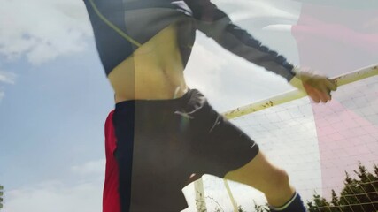 Poster - Celebrating goal, soccer player jumping with arms raised against blue sky background