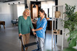 © Dorde - Professional Healthcare Worker Supporting Elderly Woman Using Walker During Physical Therapy Session In Contemporary Medical Center