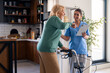 © Dorde - Smiling Female Physiotherapist Assists Elderly Woman with Walker in Bright Indoor Setting