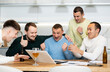 © JackF - Group of joyful friends watching football match on a laptop together and drinking beer