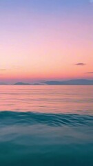 Wall Mural - vertical 9:16 soft pastel sunset backdrop with gradients of pink, orange, and purple, over a calm se