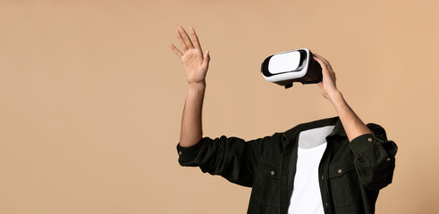 Poster - A person enjoys a virtual reality experience, wearing a headset and waving their hand. The background is a solid beige, emphasizing the focus on the user and their interaction with virtual worlds.