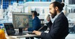 © DC Studio - Photovoltaics factory worker monitors system performance, drinking coffee. Solar panels manufacturing plant employee enjoys beverage while using PC to track energy production and efficiency, camera B