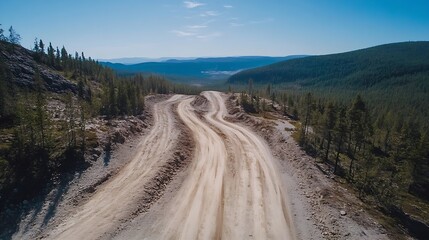 Aufkleber - Aerial view of a winding dirt road surrounded by lush forests and mountains : Generative AI