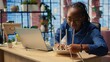 © DC Studio - African american woman restarting her wireless router and checking network settings to resolve an internet error disrupting her daily tasks. Frustration due to signal loss. Camera A.