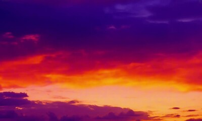 Wall Mural - dramatic backdrop with fiery orange and red sunset clouds blending into a deep purple sky, vivid and