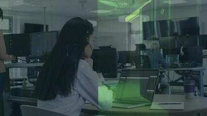  - Businesswoman working on laptop with digital data processing animation overlay