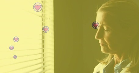 Poster - Heart icons floating around woman looking out window with animation effect