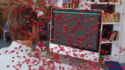 Poster - Person working at desk with red heart animation over computer screen