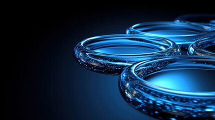 Poster - A close up of four blue glass spheres. The spheres are all the same size and are placed in a row. The image has a calm and serene mood, as the blue color of the spheres creates a sense of tranquility