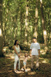 © Roman - Happy Family Enjoying an Outdoor Stroll Together in a Scenic Forest Setting