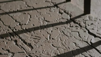 Poster - Dramatic shadow play on textured surface creating abstract patterns