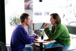 © Westend61 - Two people having a business discussion in a caf� with smartphones