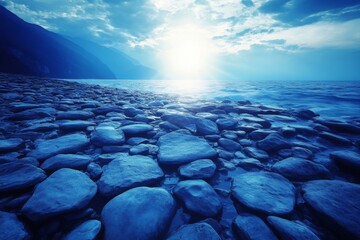 Aufkleber - Tranquil waters reflecting sunlight over a rocky shoreline at dawn