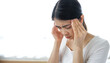 © Ton Photographer4289 - Young woman touching her temples with her hand because of severe headache due to stress or migraine. Health and mental health problem concept.