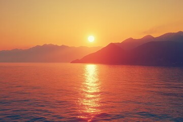 Aufkleber - Sunset over calm ocean waters with mountains in the background during evening hours