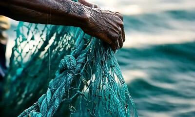A close-up image of a weathered hand gripping a turquoise fishing net over blurred water.