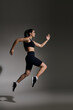 © LIGHTFIELD STUDIOS - Dynamic sprint of a young athletic woman showcasing her fitness and determination in a sleek outfit