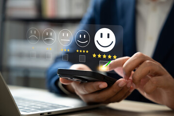 Wall Mural - customer satisfaction survey concept, businessman using smartphone touch happy smiley icon, 5 star s