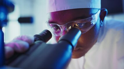 Wall Mural - focused scientist wearing protective gear analyzing molecular sample through advanced microscope in 