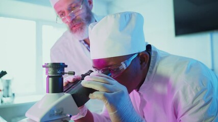 Wall Mural - medical research professionals analyzing scientific samples using advanced microscope and laptop, co