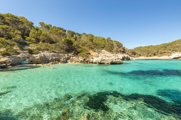 Fototapete - The picturesquely beautiful coast of the island of Menorca and the beach of Cala Mitjana Azure water, clear water of the Mediterranean Sea. The holiday landscape of Spain