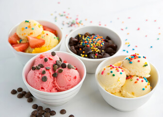 Poster - four bowls of ice cream with different toppings. One bowl has colorful sprinkles, another has chocolate chips, a third has chocolate pieces, and the last has fruit pieces.