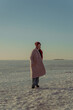 © Stanislava - Girl in coat in winter on the background of snow and ice at sunset