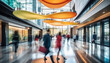 © astaszczyk - Blurred people walking in motion in modern lobby.