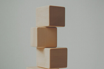 Poster - Stacked Blocks: A minimalist composition of three wooden blocks delicately balanced, showcasing the interplay of light and shadow, creating a sense of equilibrium.