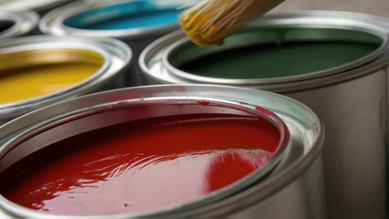 Poster - Closeup of paint being applied to the exterior surface of a container showcasing vibrant color choices and the texture of the containers metal skin.