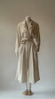 © Exsinghas - minimalist fashion display featuring single outfit on mannequin, showcasing beige shirt and wide leg pants, exuding calm and stylish vibe