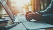 © Tania - Adult caucasian male typing on laptop at office desk in warm lighting