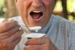 © carballo - mouth of an elderly man eating yogurt